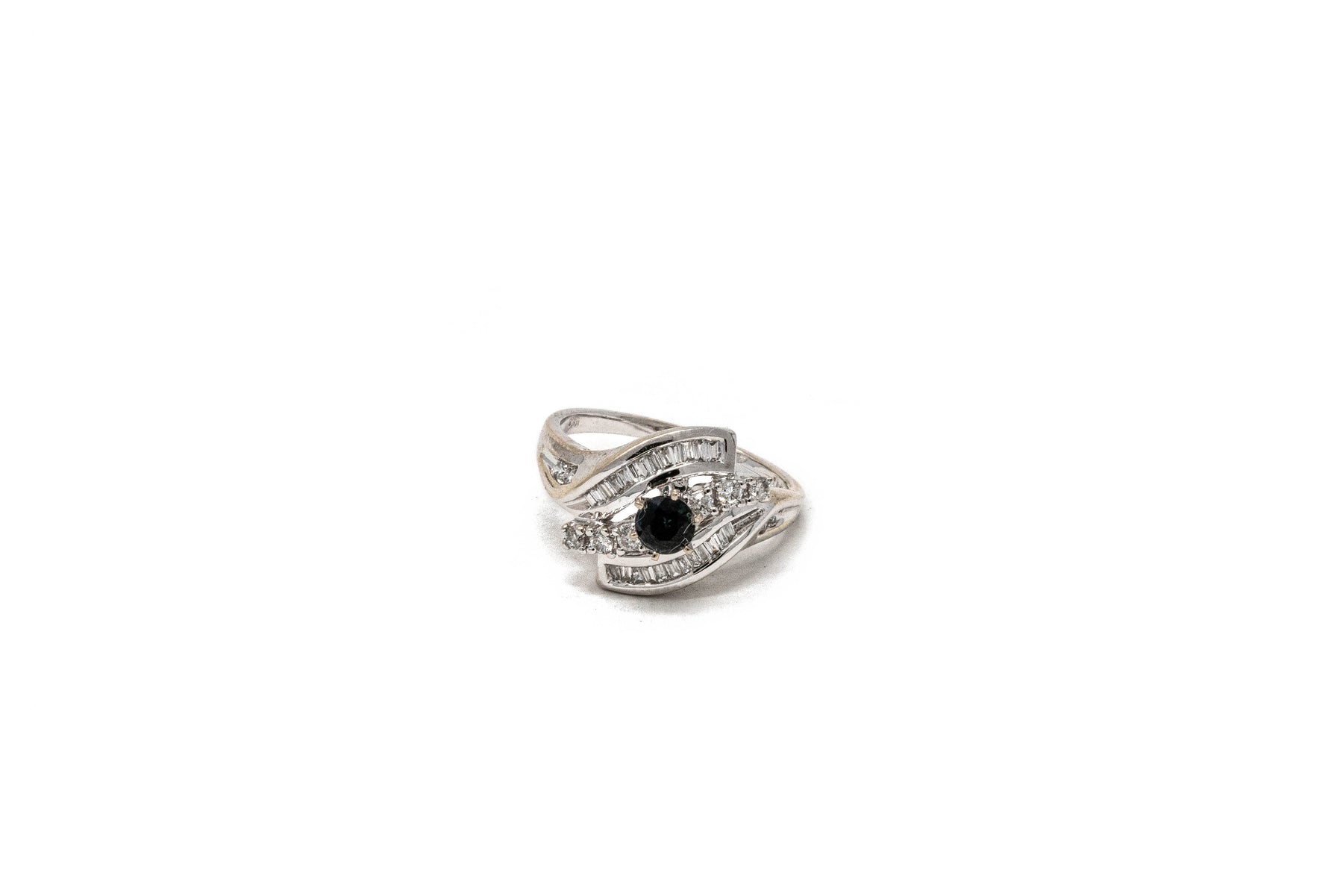 .45 point Round Cut, .15 point Tapered Baguette Cut, and .25 point Round Brilliant Cut Diamond Ring