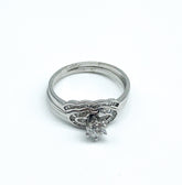 .26 Point Round Brilliant Cut and .28 Point Baguette Cut Diamond Ring