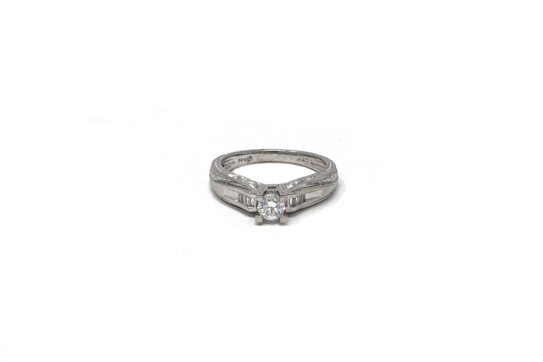 .36 point Round Brilliant Cut and .12 point Baguette Cut Diamond Ring