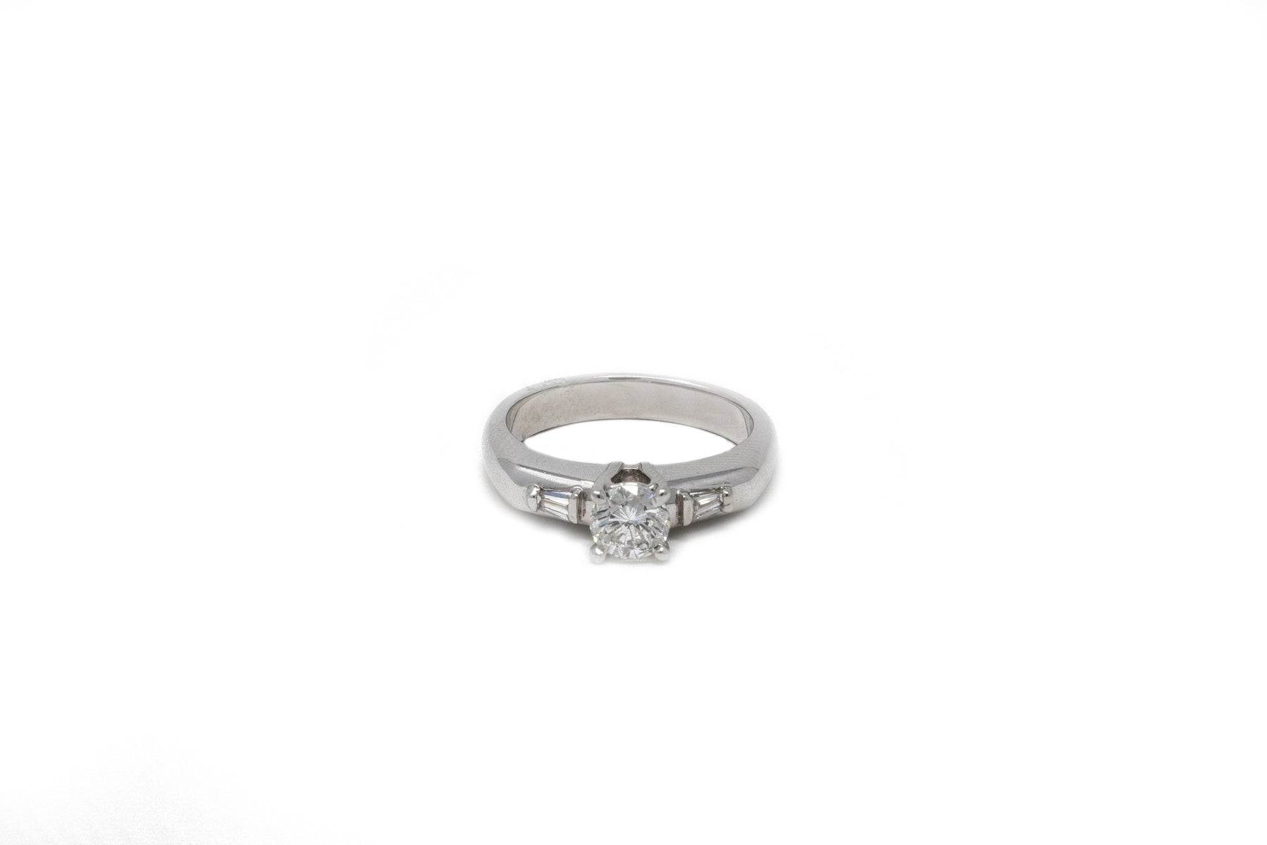 .64 point Round Brilliant Cut and .16 point Tapered Baguette Cut Diamond Ring
